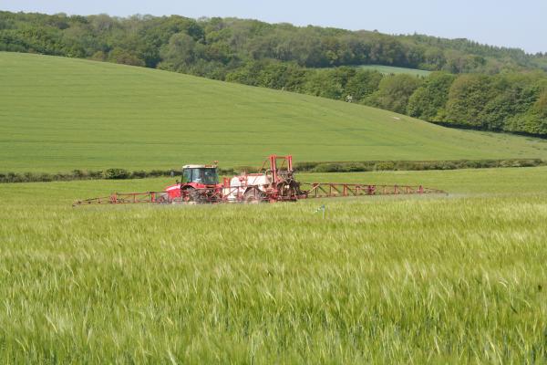 Tractor spraying crops