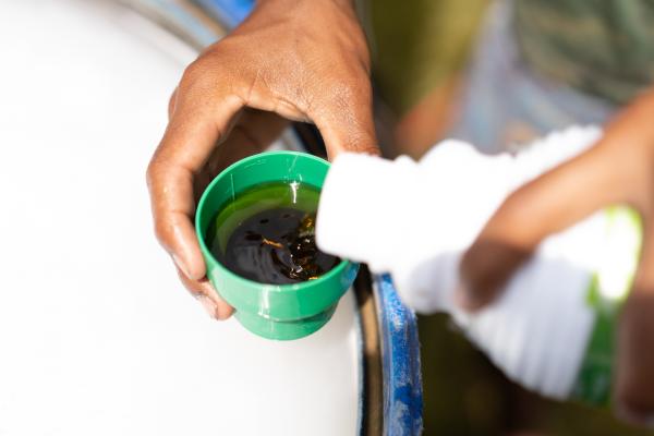 Man pouring and mixing fungicidal plant protection product.