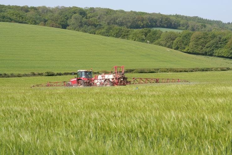 Tractor spraying crops