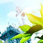 Chemical Manufacturing Site with Lush Greenery in foreground.